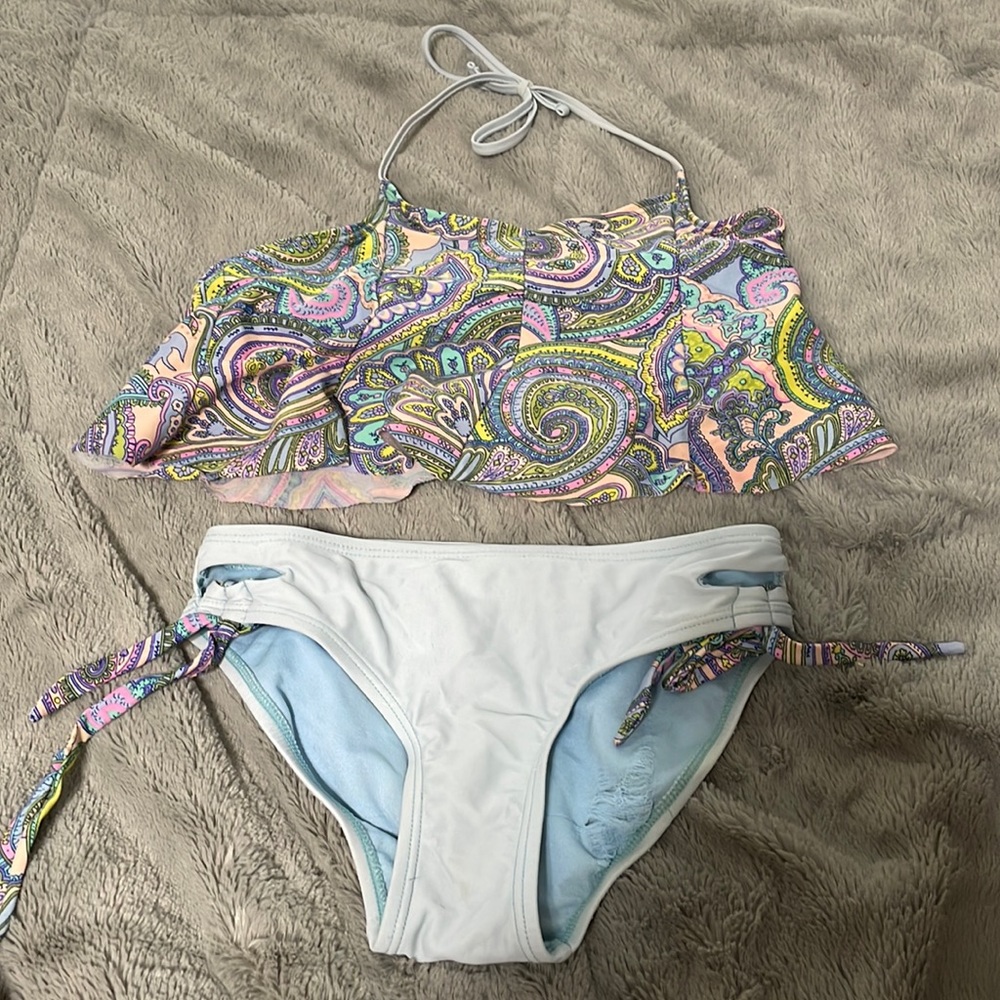 Has a rip on the inside of the bottoms and some discoloration from wear